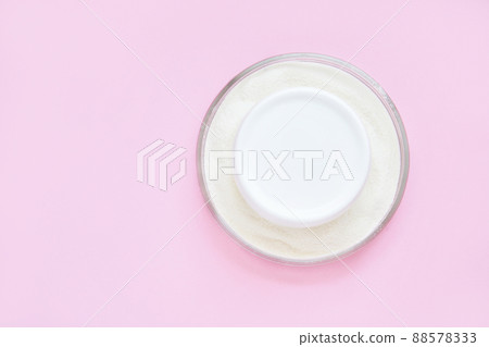 Collagen white powder. Pastel color background. Health product. Woman cosmetics Collagen white powder. Pastel color background. Health product. Woman cosmetics 88578333