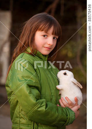 Portrait of a girl with a white rabbit Portrait of a girl with a white rabbit 88578436