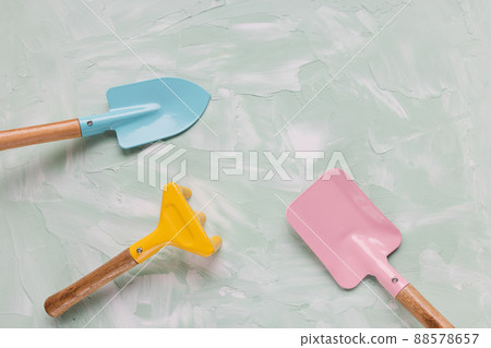 Small gardening tools for pot plants on green background. Small shovel and rakes 88578657