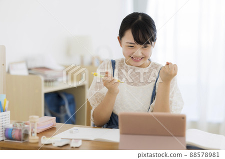 Girl studying on a tablet PC Online learning 88578981