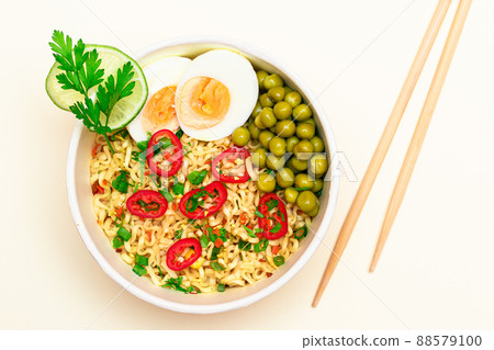 Beautiful Noodle Dish with Green Pea, Eggs, Red Hot Pepper and Greens Beautiful Noodle Dish with Green Pea, Eggs, Red Hot Pepper and Greens 88579100