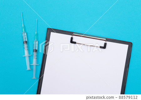 Vaccination or Revaccination Concept - Two Medical Syringe on Blue Table 88579112