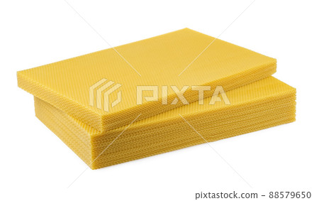 Beeswax. Wax base for honey bee rebuilding on a white background. Honeycombs. Beeswax. Wax base for honey bee rebuilding on a white background. Honeycombs. 88579650