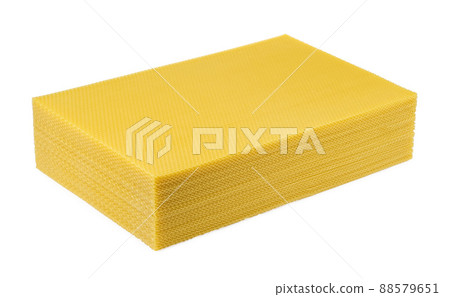 Beeswax. Wax base for honey bee rebuilding on a white background. Honeycombs. 88579651
