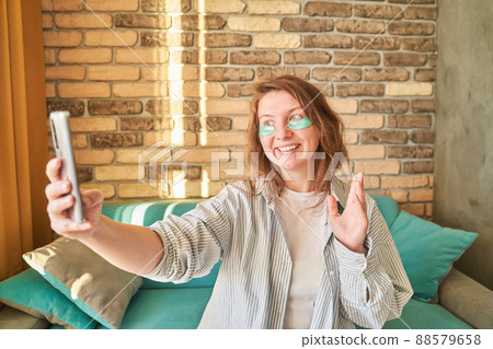 Young woman doing self portrait indoors. Home vacation portrait. Blogger Young woman doing self portrait indoors. Home vacation portrait. Blogger 88579658