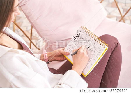 Young woman drawing neurographics indoors. Psychology treatment 88579701