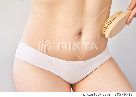 skin care. Body brush routine. Woman belly peeling. Female person drainage scrub skin care. Body brush routine. Woman belly peeling. Female person drainage scrub 88579718