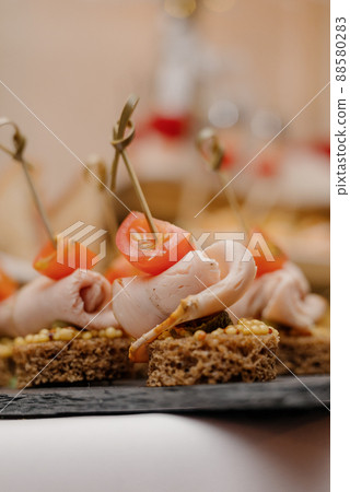 Cheese canapes with wine on table. Catering. 88580283