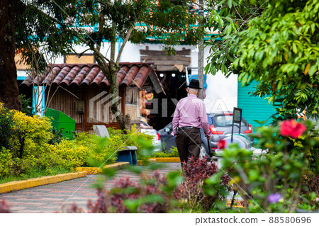 Senior man at the central square in the beautiful colonial town of Filandia in the region of Quindio in Colombia 88580696