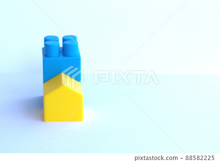 Small house made of children's designer color Ukraine Flag, white. Concept of a new home. 88582225