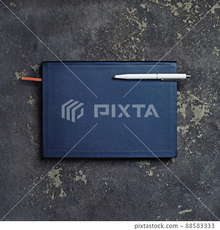 Closed notepad and pen Closed notepad and pen 88583333