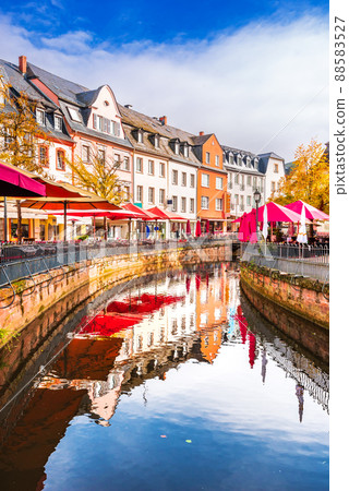 Saarburg, Germany - Old town and touristic Leukbach water reflection Saarburg, Germany - Old town and touristic Leukbach water reflection 88583527