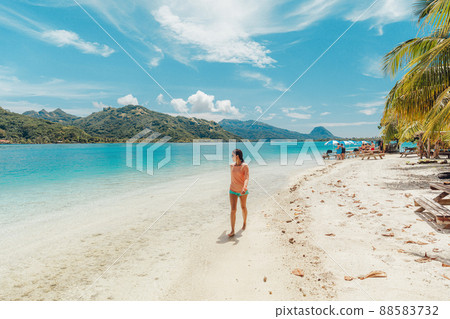 French Polynesia Travel beach picnic motu tour on Huahine, Tahiti, French Polynesia. Happy tourist woman walking on perfect beach living healthy lifestyle 88583732