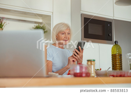 Retired woman resting at cozy home kitchen Retired woman resting at cozy home kitchen 88583813