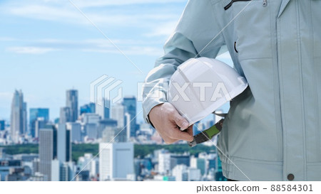 Construction workers against the backdrop of the city 88584301
