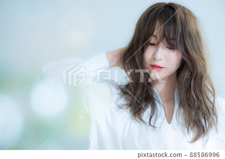 Women's hair care in white blouse Women's hair care in white blouse 88586996