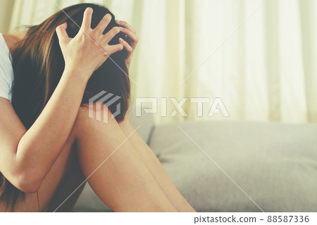 A woman sitting stressed, depressed, insomnia who broke up with her boyfriend. 88587336