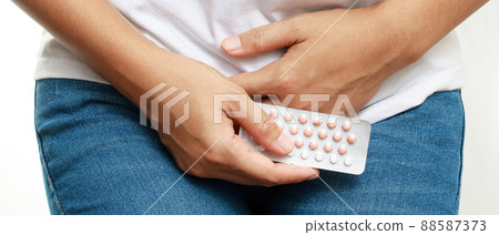 Woman take birth control pills before sex. Woman take birth control pills before sex. 88587373