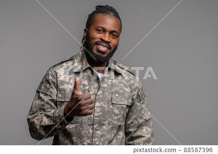 Joyous soldier showing a sign of approval before the camera 88587396