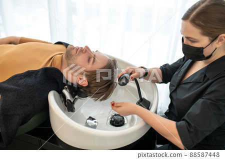 Male customer sitting at the chair in the hairdressing salon 88587448
