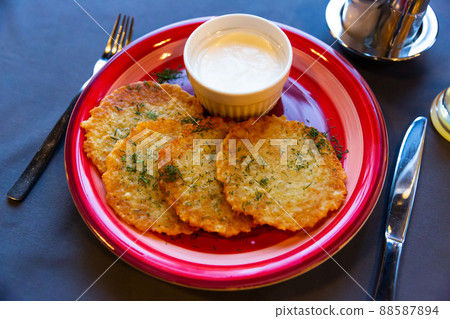 Belarusian traditional potato pancakes with sour cream Belarusian traditional potato pancakes with sour cream 88587894
