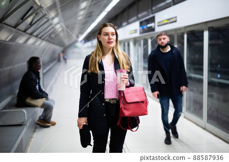 Young woman waiting for train in underground station Young woman waiting for train in underground station 88587936