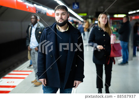 Young man waiting for subway train Young man waiting for subway train 88587937