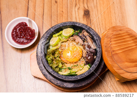 Korean traditional dish- bibimbap mixed rice with vegetables Include beef and fried egg Korean traditional dish- bibimbap mixed rice with vegetables Include beef and fried egg 88589217