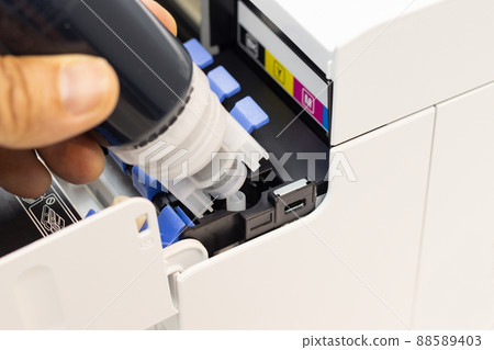 Technicians are installing setup the ink and Insert ink into the fill hole. of an inkjet printer, the device of office automate for printing Technicians are installing setup the ink and Insert ink into the fill hole. of an inkjet printer, the device of office automate for printing 88589403