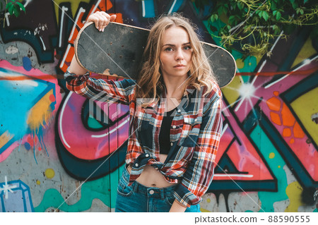 Woman riding a skateboard on colorful street art. Skater girl on a longboard. Cool female skateboarder at sunset. Carefree female skater 20s enjoying freedom youth lifestyle Hobby Woman riding a skateboard on colorful street art. Skater girl on a longboard. Cool female skateboarder at sunset. Carefree female skater 20s enjoying freedom youth lifestyle Hobby 88590555
