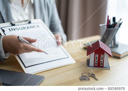 Insurance concept the realtor pointing his pen and suggesting his client to sign the name 88590970