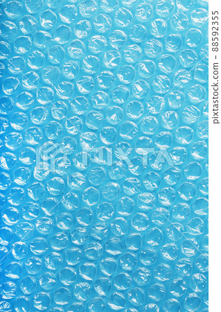 Packing bubble wrap for parcels on a blue background in full screen Packing bubble wrap for parcels on a blue background in full screen 88592355