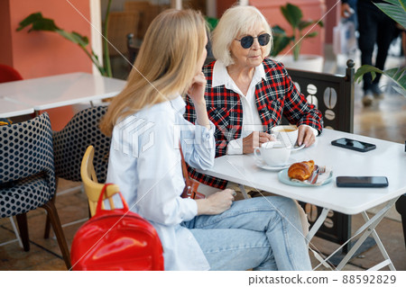 Elderly lady with young woman in cafe Elderly lady with young woman in cafe 88592829