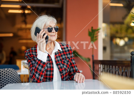 Portrait of pensioner lady using smartphone in city Portrait of pensioner lady using smartphone in city 88592830