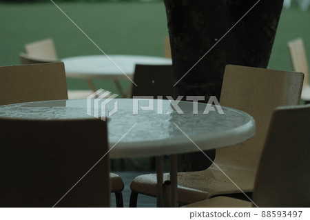 Rainy summer resort spacious yard white table in the rain 88593497