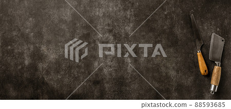 Kitchen background with copy space. Vintage meat cleaver and knife on dark gray stone table 88593685