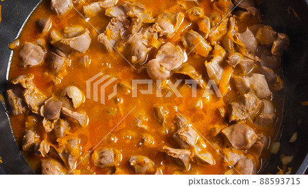 A top view of the wok with cooking chicken offal. Close-up. Asian-style cooking. A top view of the wok with cooking chicken offal. Close-up. Asian-style cooking. 88593715