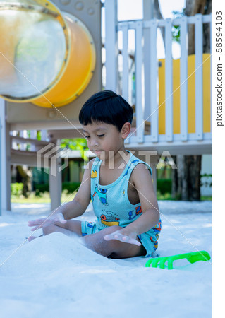 Little Boy on playground in sandpit. Little Boy on playground in sandpit. 88594103