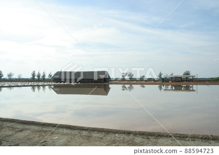 Building beside salt-pond and light blue sky, Thailand. 88594723