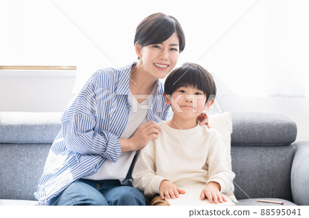 Mother watching over a child studying 88595041