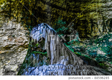 View to stalagmite under the Shakuran waterfall in Abkhazia, Geo 88596285