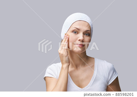 Pure skin care mature beauty portrait. Demakeup using matting tissue 88598201