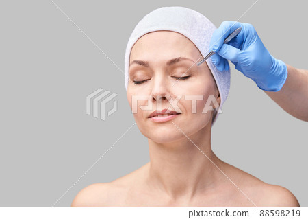 Beautician skin care. Face tweezers. Facial treatment. Woman dermatology Beautician skin care. Face tweezers. Facial treatment. Woman dermatology 88598219