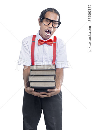 Asian nerd with an ugly face carrying a stack of books 88600572