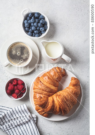Delicious breakfast with croissants, coffee and berries, gray background. 88600590