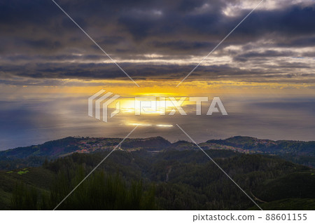 Sunset over Atlantic Ocean with coastal villages in Madeira, Portugal Sunset over Atlantic Ocean with coastal villages in Madeira, Portugal 88601155