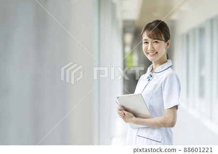 Image of a smiling nurse holding a tablet as a medical worker Image of a smiling nurse holding a tablet as a medical worker 88601221