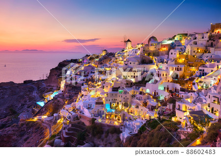 View of traditional houses in Santorini. Small narrow streets and rooftops of houses and hotels.  88602483