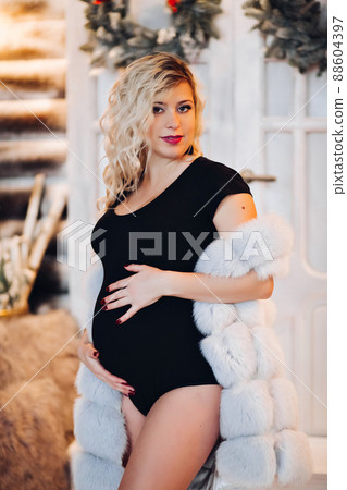 Beautiful pregancy mom lying at studio decorated 88604397