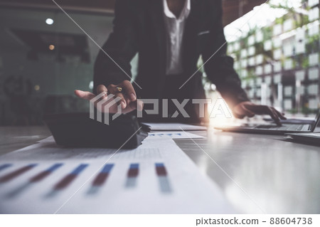 Close up Business woman hand using calculator to calculate the company's financial results and budget. Account Audit Concept. Close up Business woman hand using calculator to calculate the company's financial results and budget. Account Audit Concept. 88604738